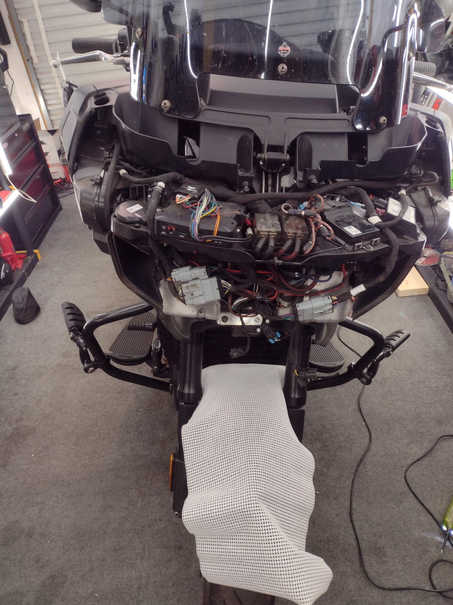 Indian motorcycle fairing removed showing wiring harness during audio installation
